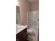 Cozy bathroom with a shower/tub combo, white toilet and vanity with dark wood drawers at 6691 Beekman Pl, Zionsville, IN 46077