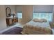 Serene bedroom with natural light, vintage vanity, and plush bedding at 6691 Beekman Pl, Zionsville, IN 46077