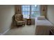 Inviting bedroom featuring a comfortable daybed, classic chair, and a bright window at 6691 Beekman Pl, Zionsville, IN 46077