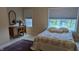 Comfortable bedroom with natural light, a vanity, and a calming color palette, creating a peaceful retreat at 6691 Beekman Pl, Zionsville, IN 46077