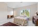 Sunlit bedroom with plush carpeting, large windows, and classic wood furnishings at 6691 Beekman Pl, Zionsville, IN 46077