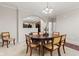 Cozy dining area with wood table, chairs, and a view into the kitchen at 6691 Beekman Pl, Zionsville, IN 46077