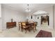 Dining area with wooden table set, classic décor, and an open view to the kitchen at 6691 Beekman Pl, Zionsville, IN 46077