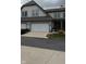 Townhome with two-car garage and manicured landscaping, well-maintained exterior at 6691 Beekman Pl, Zionsville, IN 46077