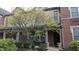 Brick townhome exterior featuring a covered entryway and well-maintained landscaping in a residential community at 6691 Beekman Pl, Zionsville, IN 46077
