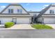 Well-maintained home with attached garages, manicured garden, and front entry at 6691 Beekman Pl, Zionsville, IN 46077