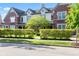 Charming townhome with brick and siding, complemented by manicured hedges and lush greenery at 6691 Beekman Pl, Zionsville, IN 46077