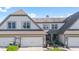 Charming townhome exterior with a two-car garage, complemented by manicured landscaping and a cozy front entrance at 6691 Beekman Pl, Zionsville, IN 46077