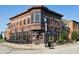 Corner building with outdoor seating showcasing brick facade and large windows at 6691 Beekman Pl, Zionsville, IN 46077