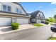 Home exterior with attached garages, manicured garden, and front entry at 6691 Beekman Pl, Zionsville, IN 46077