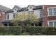Exterior shot of townhome featuring brick and siding, gray shingles, and a tree in the front yard at 6691 Beekman Pl, Zionsville, IN 46077
