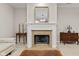 Close-up of the fireplace with decorative mantel, complemented by elegant furnishings at 6691 Beekman Pl, Zionsville, IN 46077
