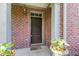 Inviting brick facade showcases the front door with dark wood and decor at 6691 Beekman Pl, Zionsville, IN 46077