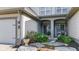 Welcoming front entrance featuring stone pathway, mature landscaping, and covered entryway with column accents at 6691 Beekman Pl, Zionsville, IN 46077