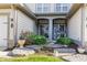 Charming entrance with stone pathway, flower beds, and manicured landscaping at 6691 Beekman Pl, Zionsville, IN 46077
