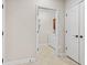 Hallway view leading into the Laundry Room, showcasing convenient accessibility at 6691 Beekman Pl, Zionsville, IN 46077