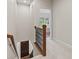 Upstairs hallway with wood railing leads to a bedroom with plenty of natural light at 6691 Beekman Pl, Zionsville, IN 46077