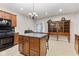 Well-appointed kitchen with an island, wooden cabinets, and plenty of counter space for cooking and entertaining at 6691 Beekman Pl, Zionsville, IN 46077