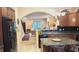 Functional kitchen with dark cabinetry and granite countertops at 6691 Beekman Pl, Zionsville, IN 46077
