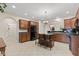 Well-appointed kitchen featuring a center island with seating and dark countertops, complemented by tiled flooring at 6691 Beekman Pl, Zionsville, IN 46077