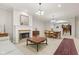 A spacious living room with a fireplace, classic furniture, and an open dining area at 6691 Beekman Pl, Zionsville, IN 46077