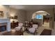 Inviting living room with fireplace, neutral walls, archway, and elegant furniture; perfect for relaxation and entertaining at 6691 Beekman Pl, Zionsville, IN 46077