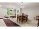 Open concept living and dining room with fireplace, sofa, and view to backyard at 6691 Beekman Pl, Zionsville, IN 46077