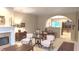 Cozy living room with fireplace, archway, and view of dining area at 6691 Beekman Pl, Zionsville, IN 46077