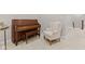 Comfortable living room featuring a vintage piano and a cozy armchair for relaxation at 6691 Beekman Pl, Zionsville, IN 46077