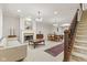 Traditional living room featuring a fireplace, staircase, and dining area at 6691 Beekman Pl, Zionsville, IN 46077