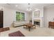 Inviting living room with fireplace, sofa, and view of the landscaped front yard at 6691 Beekman Pl, Zionsville, IN 46077