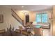 Open-concept living space with staircase, fireplace, and comfortable seating at 6691 Beekman Pl, Zionsville, IN 46077
