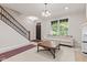 Spacious living area with staircase, fireplace, and classic sofa, offering a comfortable ambiance at 6691 Beekman Pl, Zionsville, IN 46077