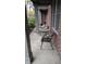 Brick patio featuring a bistro table and chairs, with partial view of greenery at 6691 Beekman Pl, Zionsville, IN 46077