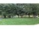 Scenic pond view surrounded by mature trees and a well-manicured lawn at 6691 Beekman Pl, Zionsville, IN 46077