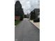 Street view with long driveway leading to well-maintained homes and lush landscaping at 6691 Beekman Pl, Zionsville, IN 46077