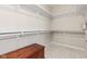 Bright walk-in closet with ample shelving and a decorative storage chest for extra capacity at 6691 Beekman Pl, Zionsville, IN 46077