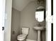 Neat half-bath with neutral walls, a pedestal sink, and an oval mirror; compact and functional at 6882 Equality Blvd, Carmel, IN 46033