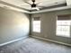Spacious bedroom featuring plush carpet, two windows and a modern ceiling fan at 6882 Equality Blvd, Carmel, IN 46033
