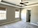 Large bedroom with two windows, plush carpet and a ceiling fan, door leading to ensuite at 6882 Equality Blvd, Carmel, IN 46033