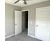Bedroom featuring neutral paint, plush carpet, and doors leading to closets and ensuite at 6882 Equality Blvd, Carmel, IN 46033