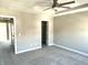 Bedroom with neutral walls, carpet, ceiling fan, and two doorways at 6882 Equality Blvd, Carmel, IN 46033