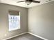 Bright bedroom showcasing plush carpet, ceiling fan and a large window with pleasant views at 6882 Equality Blvd, Carmel, IN 46033