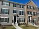 Attractive townhomes featuring a mix of siding and brick, each with well-kept front yards at 6882 Equality Blvd, Carmel, IN 46033