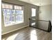 Bright foyer with beautiful hardwood floors, large windows and a modern, ornate chandelier at 6882 Equality Blvd, Carmel, IN 46033