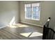 Sun-drenched foyer featuring hardwood floors and a large window, creating a warm and inviting atmosphere at 6882 Equality Blvd, Carmel, IN 46033