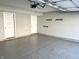 Epoxy-floored garage interior with white walls and two white doors at 6882 Equality Blvd, Carmel, IN 46033