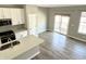 Bright kitchen area with gray floors, stainless steel appliances and direct access to outdoor patio at 6882 Equality Blvd, Carmel, IN 46033