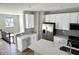 Modern kitchen featuring stainless steel appliances, gray subway tile backsplash and white cabinetry at 6882 Equality Blvd, Carmel, IN 46033