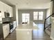 Spacious kitchen with an expansive island, stainless steel appliances, and convenient access to living area at 6882 Equality Blvd, Carmel, IN 46033